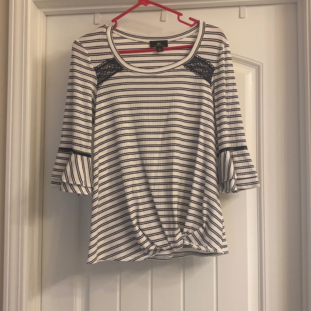 Navy and white striped shirt with flutter sleeves.